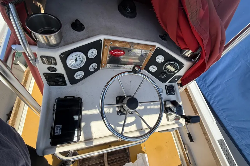 Slide: The Image of Steering console of a 2017 Mako 21 LTS boat with gauges and controls. - 6