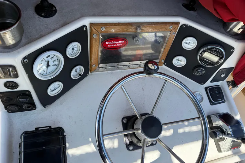Slide: The Image of Steering console of a 2017 Mako 21 LTS boat with gauges and controls. - 7