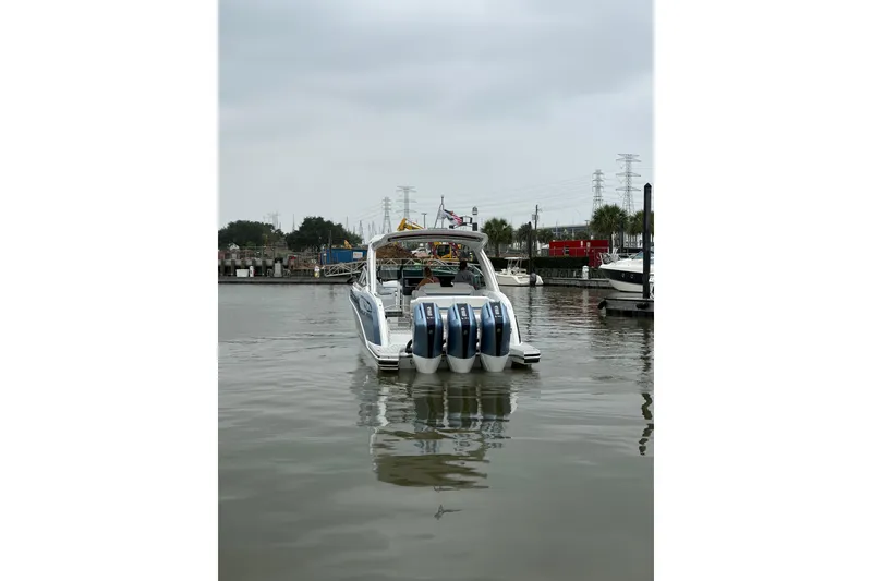 Slide: The Image of 2026 Formula 360 Crossover Bowrider OB with multiple outboard engines on a calm waterway. - 13