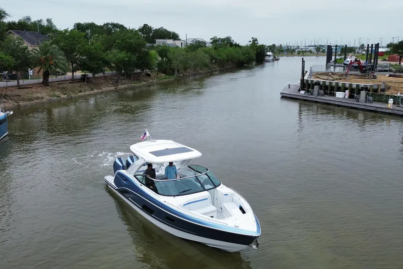 Slide: The Image of 2026 Formula 360 Crossover Bowrider OB cruising on a calm river. - 14