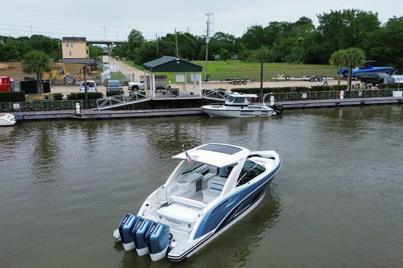 Slide: The Image of 2026 Formula 360 Crossover Bowrider OB docked in a marina, showcasing sleek design. - 15
