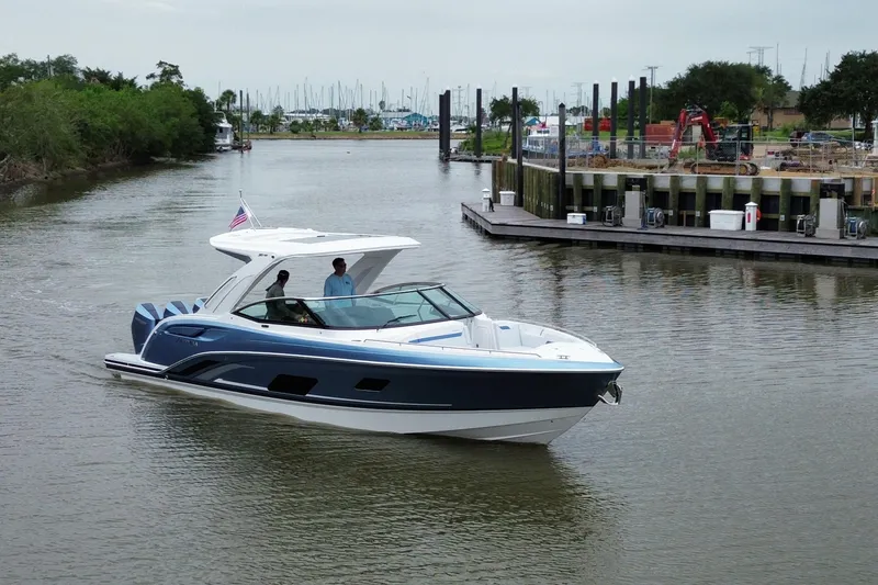 Slide: The Image of 2026 Formula 360 Crossover Bowrider OB cruising in a marina with passengers onboard. - 19