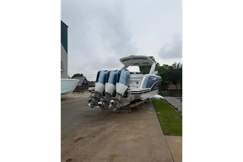 Slide: The Image of 2026 Formula 360 Crossover Bowrider OB docked at marina with triple outboard engines. - 2