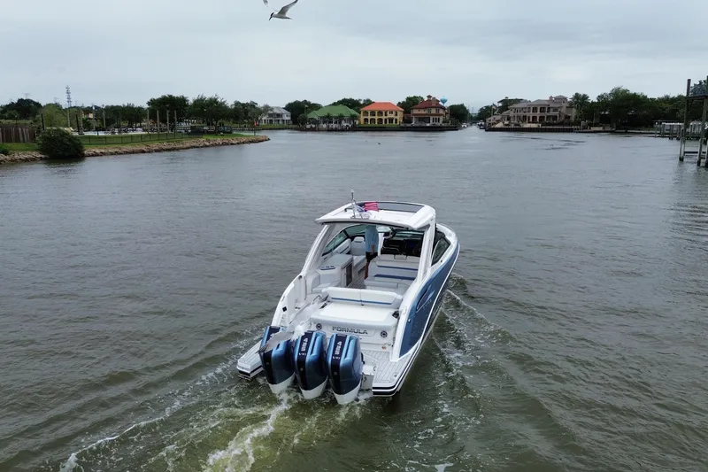 Slide: The Image of 2026 Formula 360 Crossover Bowrider OB cruising on a scenic waterway. - 20