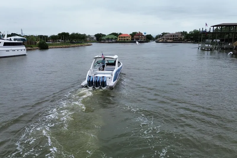 Slide: The Image of 2026 Formula 360 Crossover Bowrider OB cruising on a scenic waterway. - 22