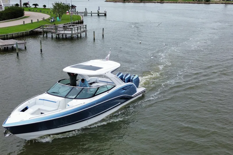 Slide: The Image of 2026 Formula 360 Crossover Bowrider OB cruising on a scenic waterway. - 24