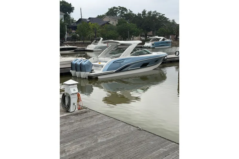 Slide: The Image of 2026 Formula 360 Crossover Bowrider OB in marina, sleek design, blue and white finish. - 3