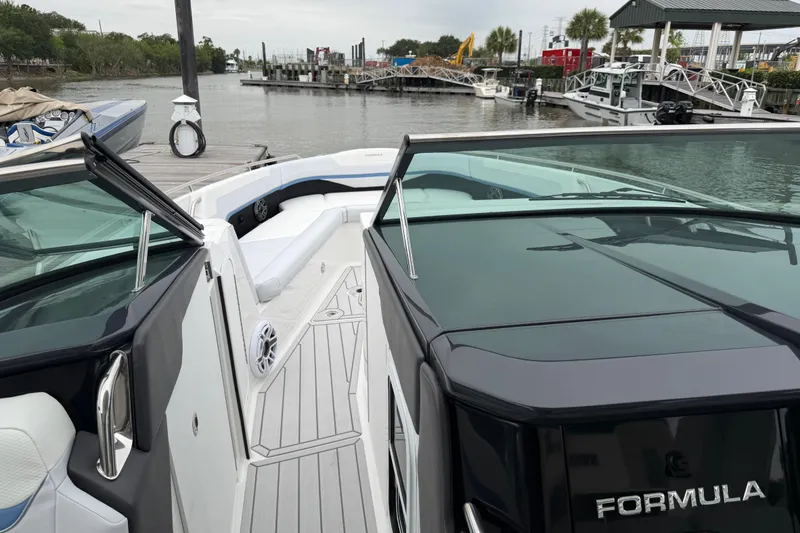 Slide: The Image of 2026 Formula 360 Crossover Bowrider OB docked, showcasing sleek design and spacious seating. - 31