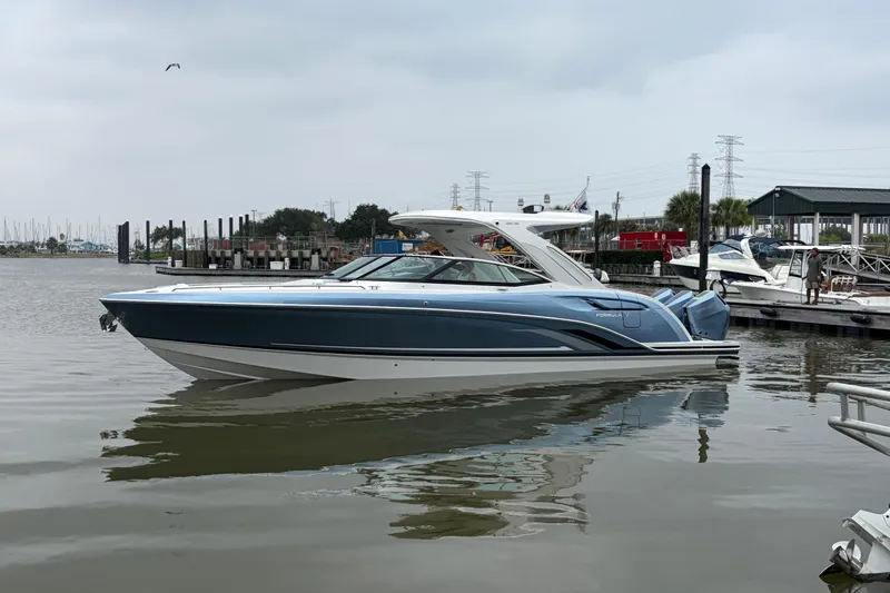 Slide: The Image of 2026 Formula 360 Crossover Bowrider OB in marina, sleek design, calm waters. - 4