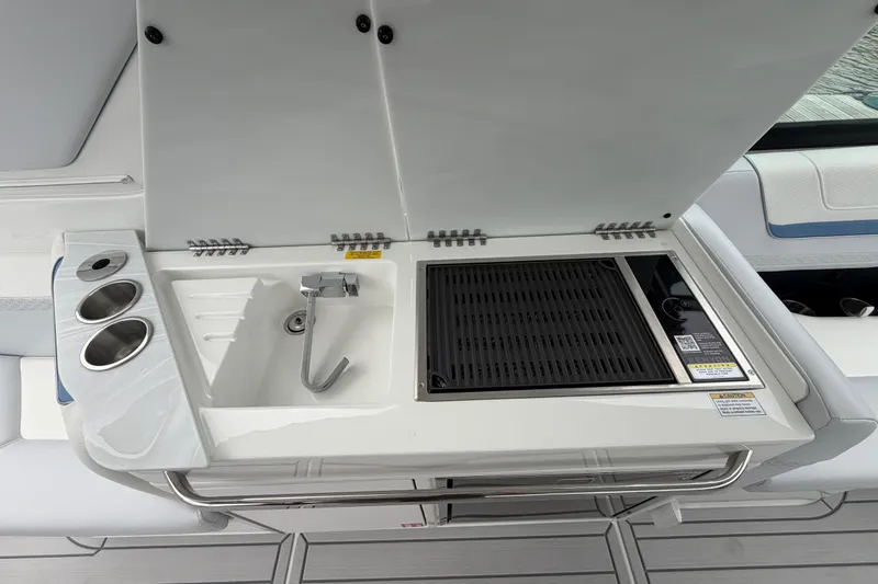 Slide: The Image of 2026 Formula 360 Crossover Bowrider OB boat kitchen with sink and grill. - 48