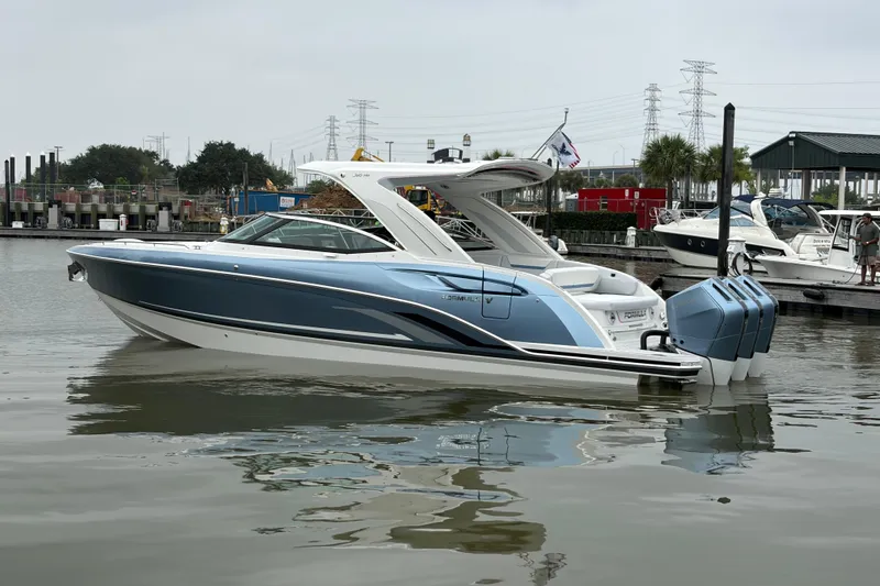 Slide: The Image of 2026 Formula 360 Crossover Bowrider OB in marina, featuring sleek design and triple outboard engines. - 6