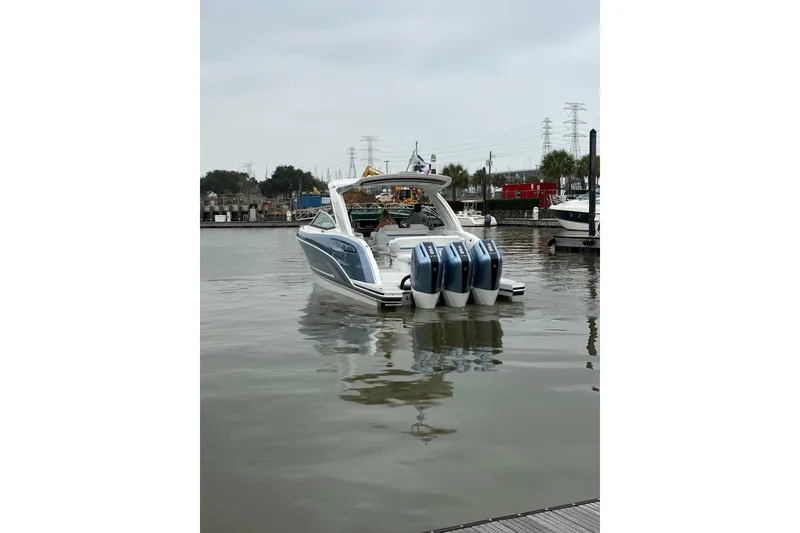 Slide: The Image of 2026 Formula 360 Crossover Bowrider OB with triple outboard engines on calm water. - 8