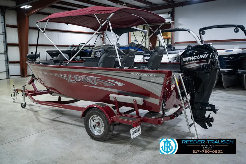 Slide: The Image of 2017 Lund 1650 Rebel XS SS boat with Mercury engine in indoor showroom. - 11