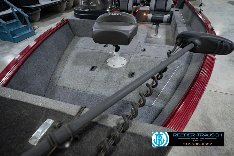 Slide: The Image of 2017 Lund 1650 Rebel XS SS boat interior with seating and trolling motor. - 14