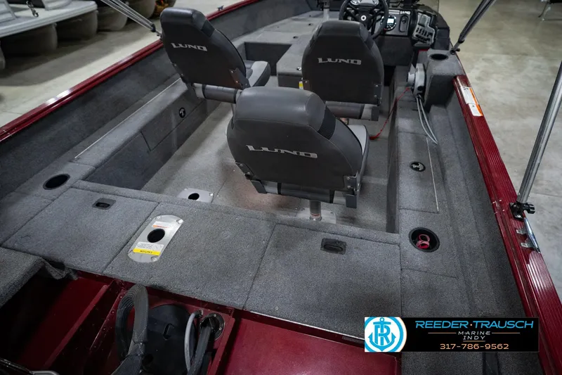 Slide: The Image of 2017 Lund 1650 Rebel XS SS boat interior with seating and storage compartments. - 17