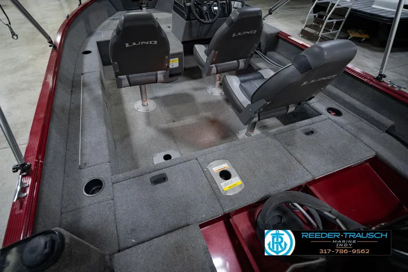 Slide: The Image of 2017 Lund 1650 Rebel XS SS boat interior with two seats and carpeted flooring. - 18