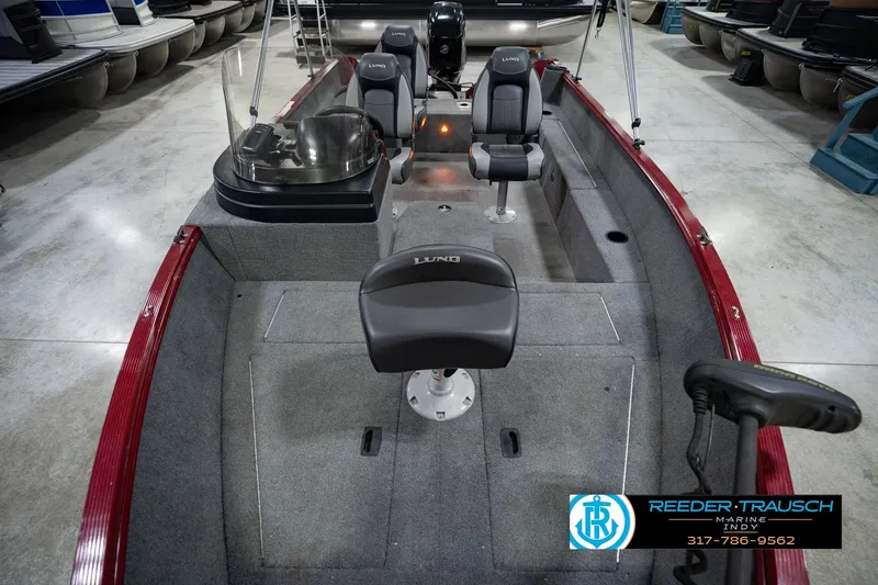 Slide: The Image of 2017 Lund 1650 Rebel XS SS fishing boat interior with seating and steering console. - 23
