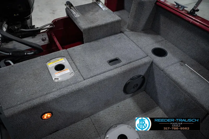 Slide: The Image of 2017 Lund 1650 Rebel XS SS boat interior with carpeted flooring and storage compartments. - 27