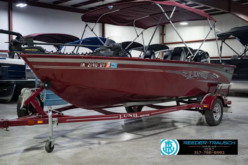 Slide: The Image of 2017 Lund 1650 Rebel XS SS boat in showroom, red color, on trailer. - 3