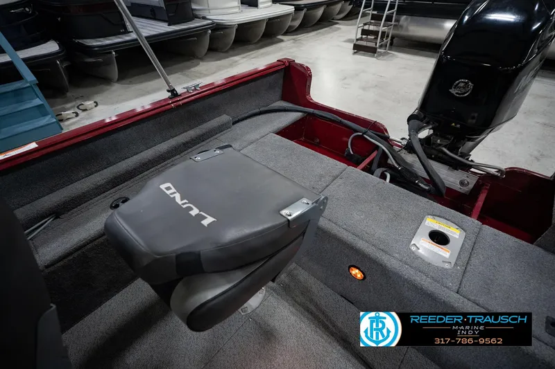 Slide: The Image of 2017 Lund 1650 Rebel XS SS boat interior with motor and seating. - 31