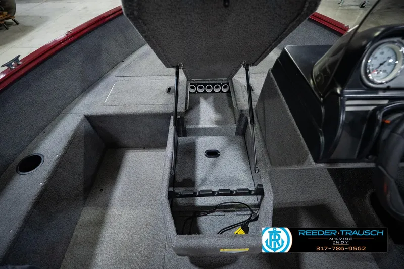 Slide: The Image of 2017 Lund 1650 Rebel XS SS boat interior with open storage compartment and dashboard view. - 38
