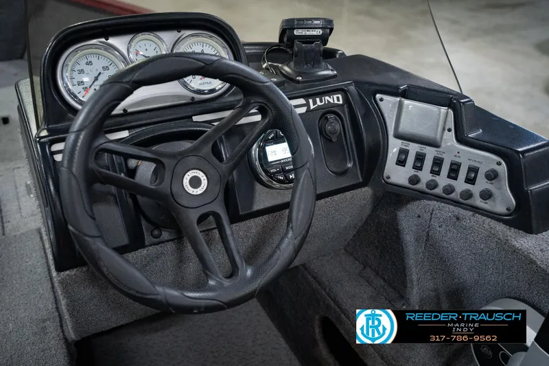 Slide: The Image of 2017 Lund 1650 Rebel XS SS boat dashboard with steering wheel and control panel. - 40