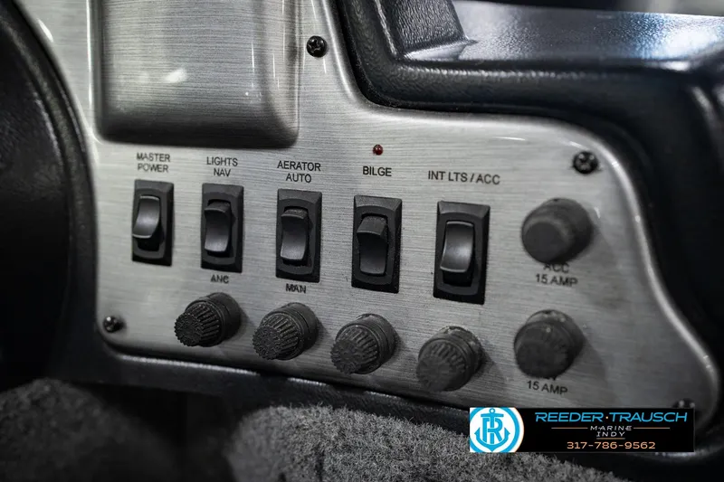 Slide: The Image of Control panel of a 2017 Lund 1650 Rebel XS SS boat with switches and knobs. - 44