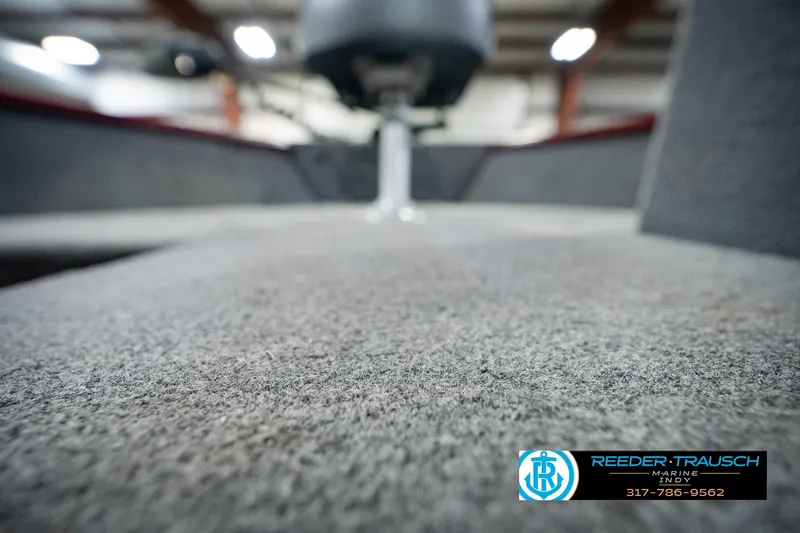 Slide: The Image of 2017 Lund 1650 Rebel XS SS boat interior with carpeted flooring, showcasing Reeder Trausch Marine logo. - 48