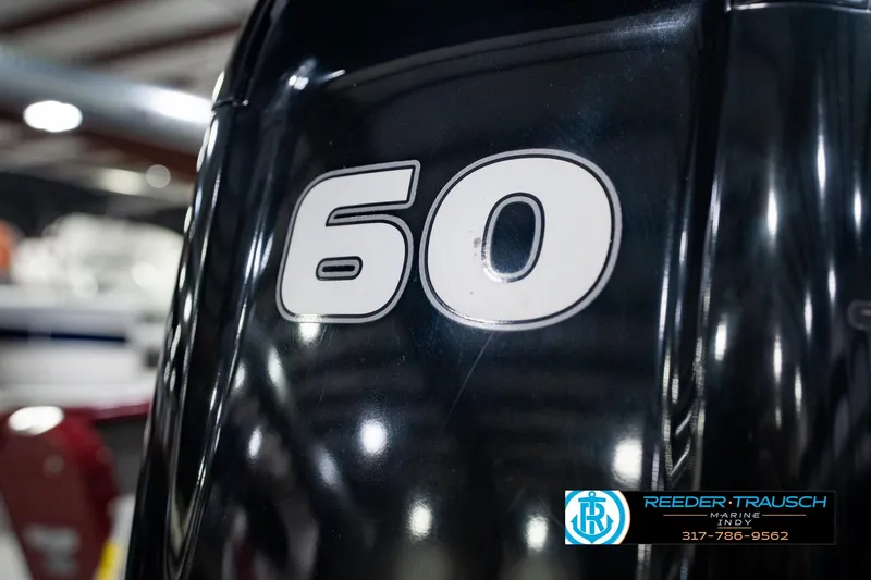 Slide: The Image of Close-up of a 2017 Lund 1650 Rebel XS SS boat engine with "60" marking. - 50