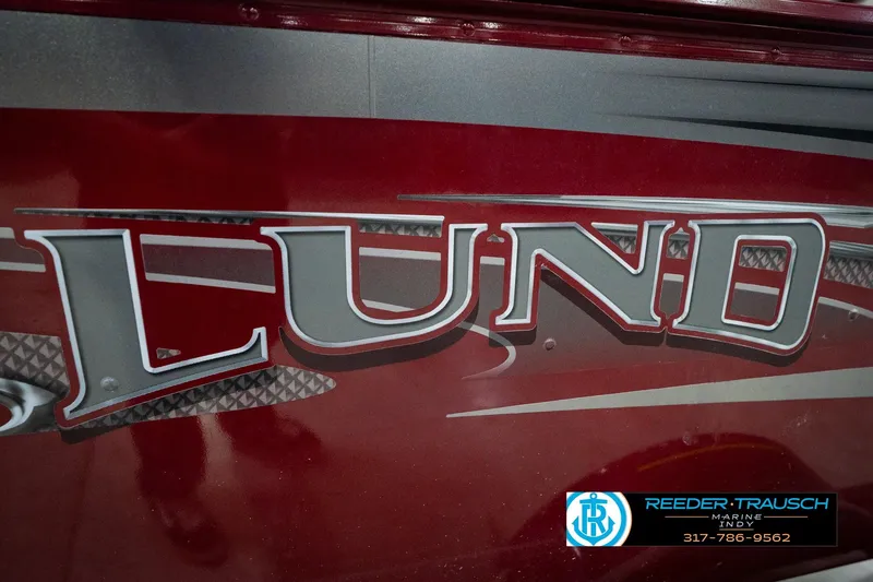 Slide: The Image of Red 2017 Lund 1650 Rebel XS SS boat with bold logo and dealership contact. - 57