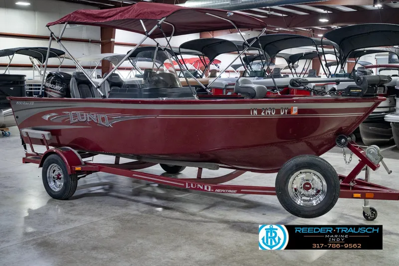 Slide: The Image of 2017 Lund 1650 Rebel XS SS boat in showroom, red color, on trailer. - 6