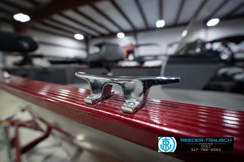 Slide: The Image of 2017 Lund 1650 Rebel XS SS boat cleat in a showroom, Reeder-Trausch Marine logo visible. - 64