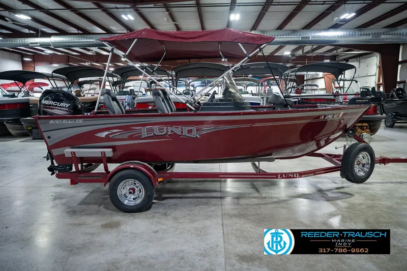 Slide: The Image of 2017 Lund 1650 Rebel XS SS boat in showroom, red color, on trailer. - 7