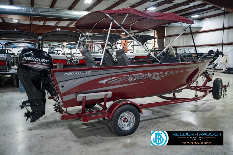 Slide: The Image of 2017 Lund 1650 Rebel XS SS boat with Mercury engine in indoor showroom. - 9