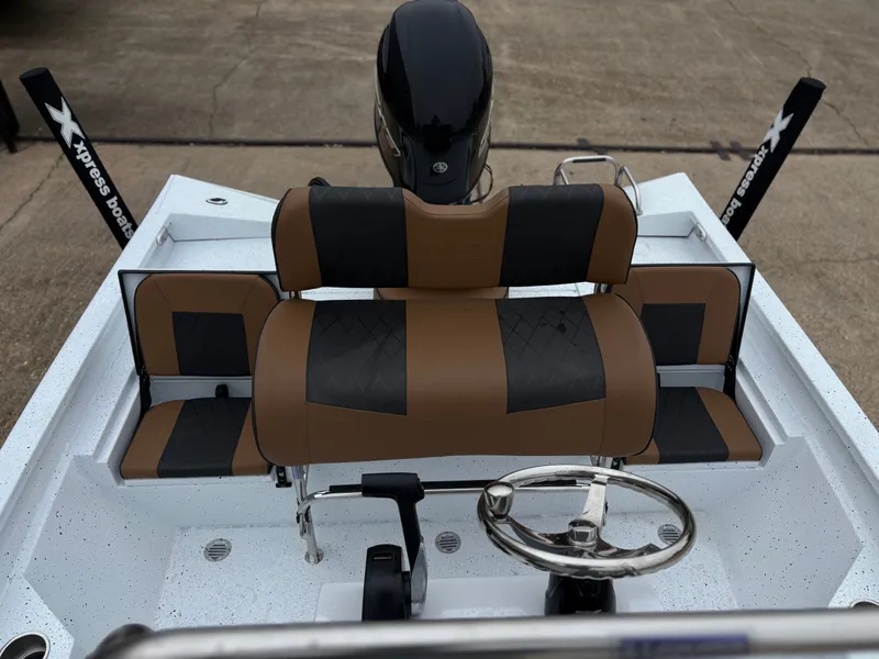 Slide: The Image of 2026 Xpress H20B HYPERLIFT-BAY boat interior with steering wheel and seats. - 6