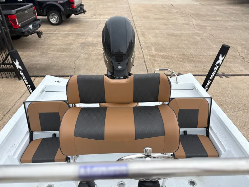 Slide: The Image of 2026 Xpress H22B HYPER-LIFT BAY boat with brown and black seats. - 5