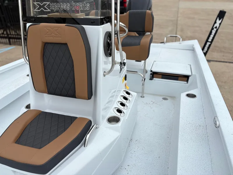 Slide: The Image of 2026 Xpress H22B Hyper-Lift Bay boat interior with brown and black seats. - 9
