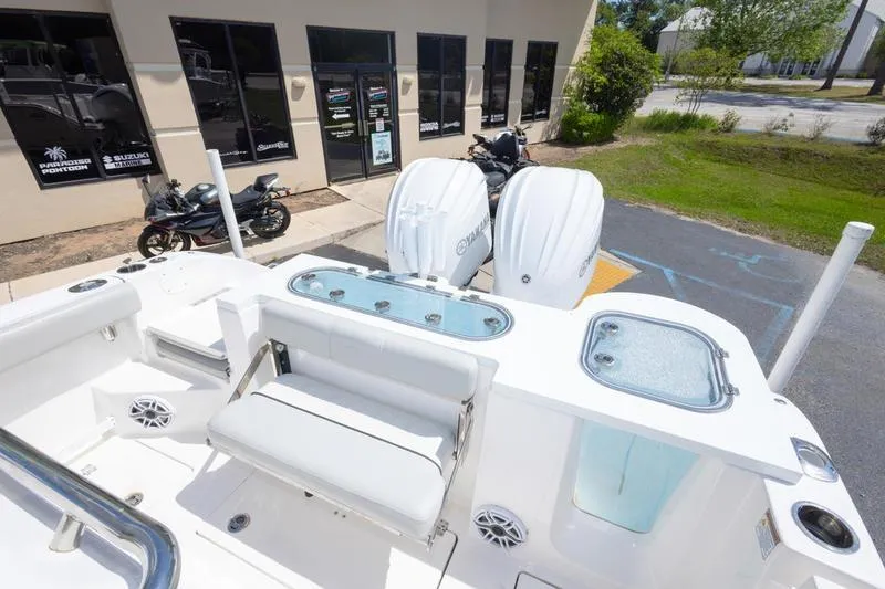 Slide: The Image of 2023 Sea Fox 288 Commander boat with dual Yamaha engines, parked outside a dealership. - 10