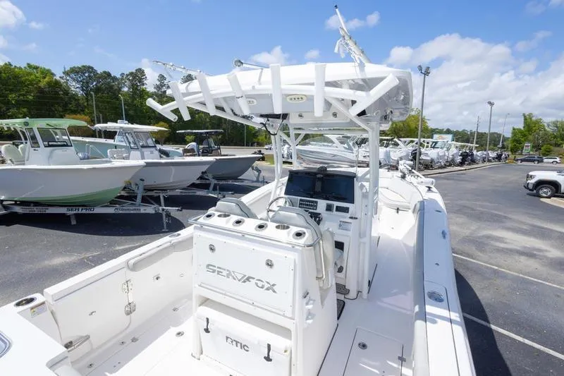 Slide: The Image of 2023 Sea Fox 288 Commander boat displayed in a marina under a clear blue sky. - 21