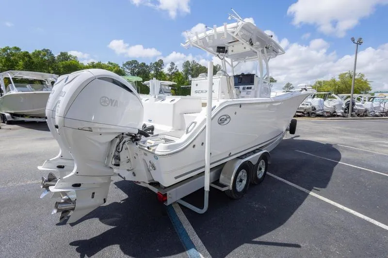 Slide: The Image of 2023 Sea Fox 288 Commander boat on trailer, featuring dual outboard engines. - 3