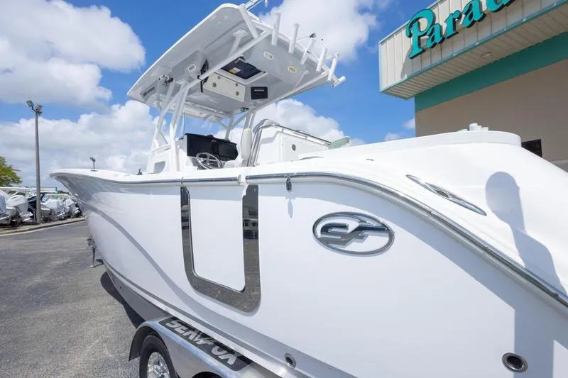 Slide: The Image of 2023 Sea Fox 288 Commander boat displayed outdoors under a clear sky. - 6
