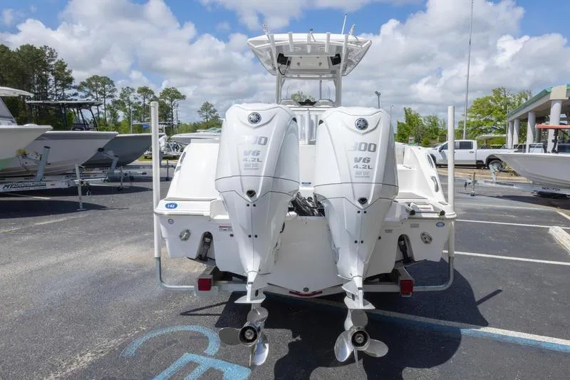 Slide: The Image of 2023 Sea Fox 288 Commander with dual outboard engines in a parking lot. - 7