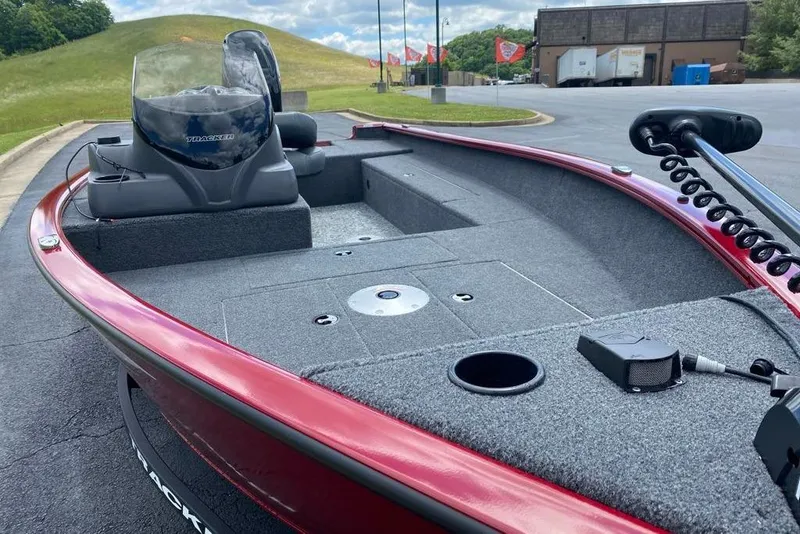 Slide: The Image of 2026 Tracker Super Guide V-16 SC fishing boat with red exterior and spacious deck. - 3