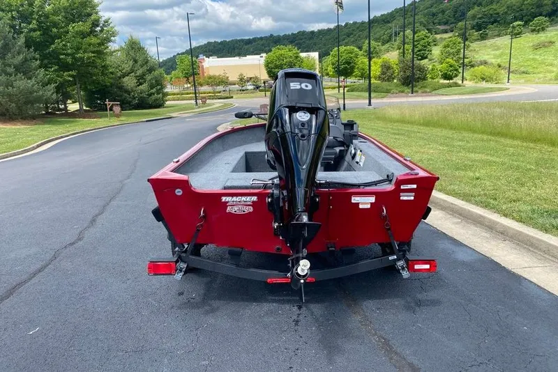 Slide: The Image of Red 2026 Tracker Super Guide V-16 SC boat with outboard motor on a trailer. - 2