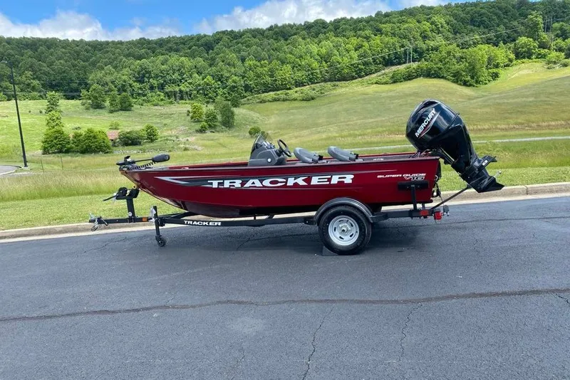 The Image of 2026 Tracker Super Guide V-16 SC boat on trailer, scenic background. - 0