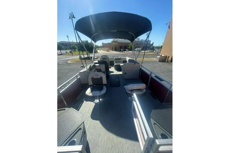 Slide: The Image of 2026 Sun Tracker Fishin' Barge 22 XP3 pontoon boat with spacious seating and canopy. - 4