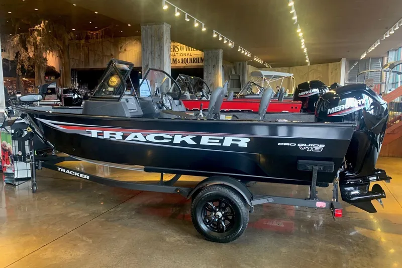 The Image of 2026 Tracker Pro Guide V-16 WT boat displayed indoors on a trailer. - 0