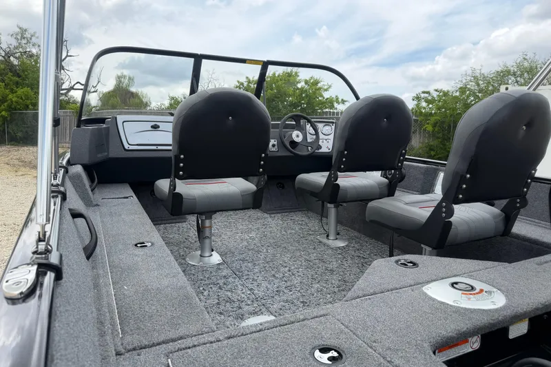 Slide: The Image of 2026 Tracker Pro Guide V-16 WT boat interior with seating and steering console. - 55