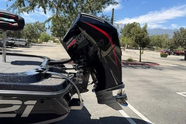 Slide: The Image of 2026 Nitro Z21 XL Pro boat with powerful outboard motor in a sunny parking lot. - 3