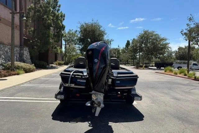 Slide: The Image of 2026 Nitro Z21 XL Pro boat parked in sunny lot, rear view. - 4